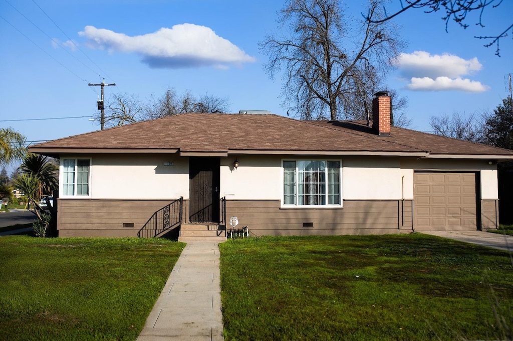 ranch-style house with a front lawn and a garage