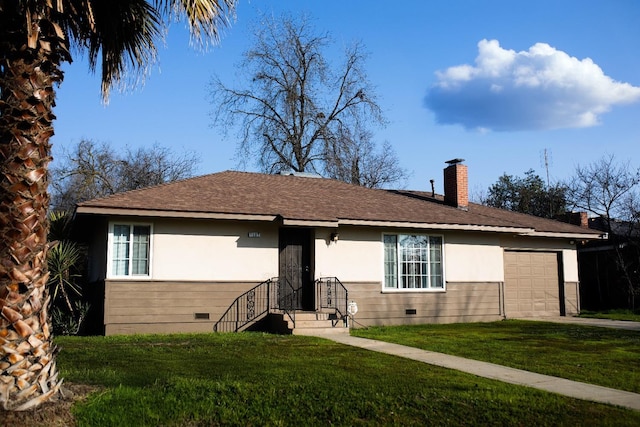 view of front facade featuring a front yard and a garage