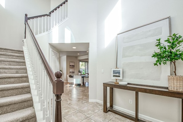 stairway with tile patterned floors