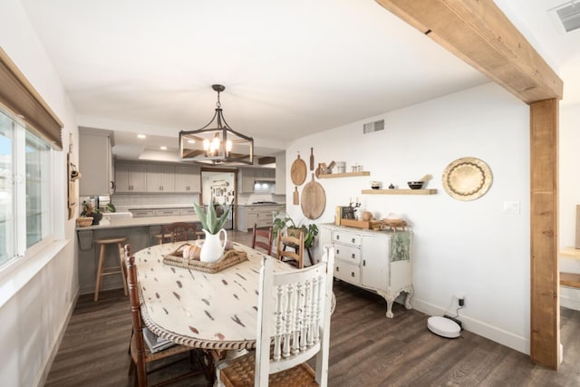 dining area featuring a chandelier and dark hardwood / wood-style floors