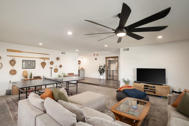 living room featuring ceiling fan and hardwood / wood-style flooring