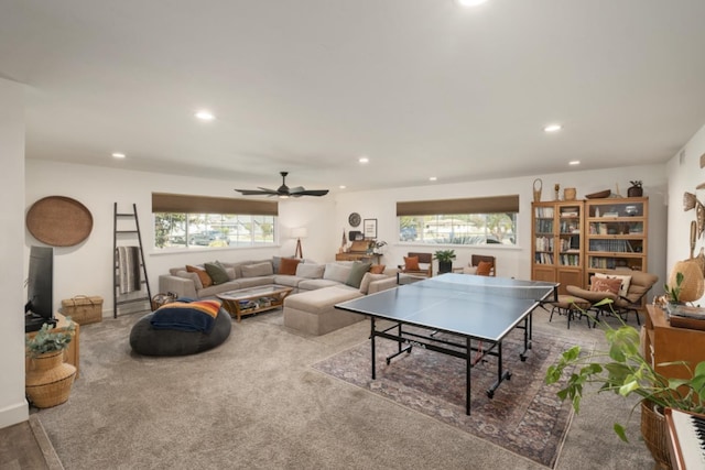 game room featuring ceiling fan, carpet flooring, and a wealth of natural light