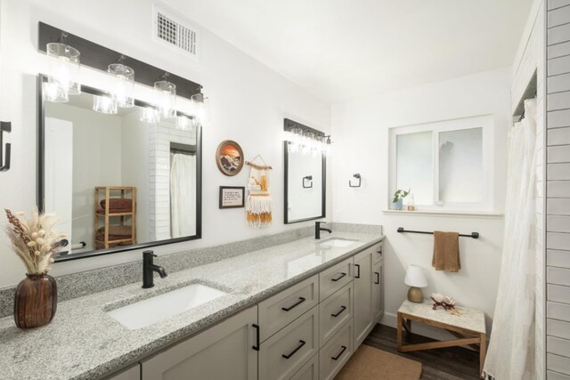 bathroom with vanity, hardwood / wood-style flooring, and curtained shower