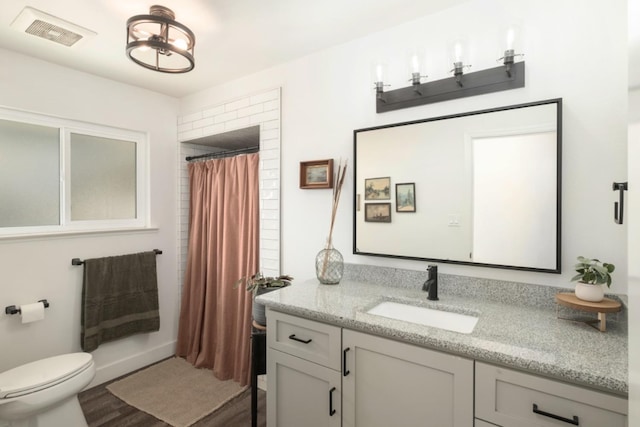 bathroom with vanity, toilet, wood-type flooring, and a shower with curtain