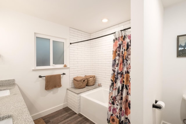 bathroom featuring shower / bath combo with shower curtain and hardwood / wood-style flooring