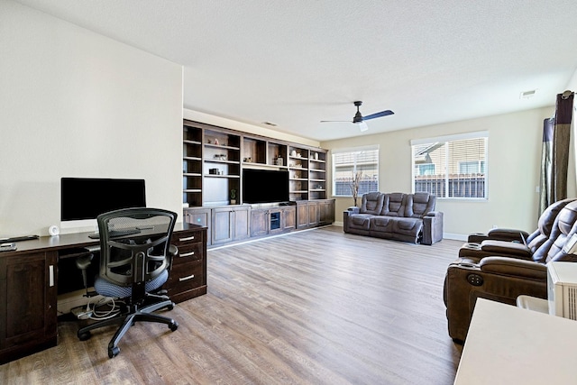 office with a textured ceiling, hardwood / wood-style flooring, and ceiling fan