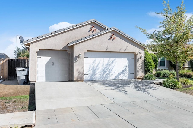 3313 Whiteash Ave, Clovis, CA 93619 - view of front facade featuring a garage, stucco siding, fence, and concrete driveway