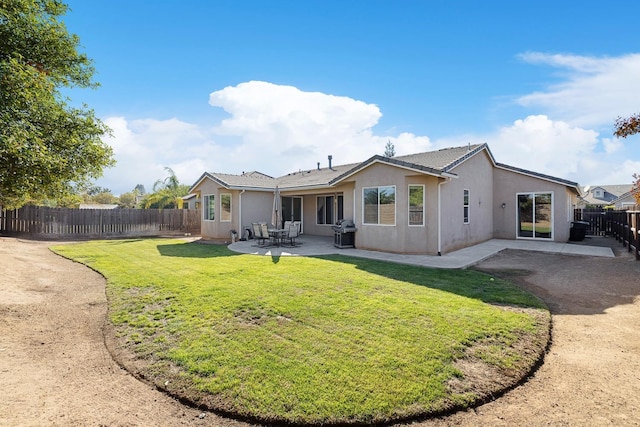 rear view of house with a patio area and a yard