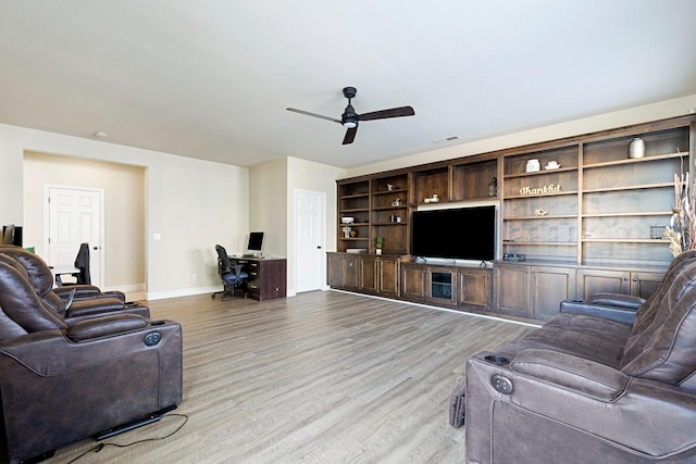 living room with light hardwood / wood-style flooring and ceiling fan