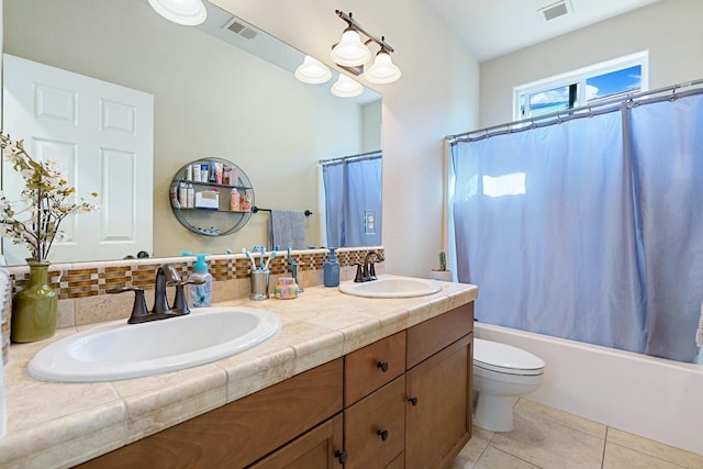 full bathroom with toilet, shower / bath combo, vanity, and tile patterned flooring