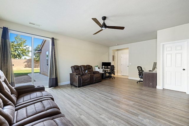 living room with hardwood / wood-style floors and ceiling fan