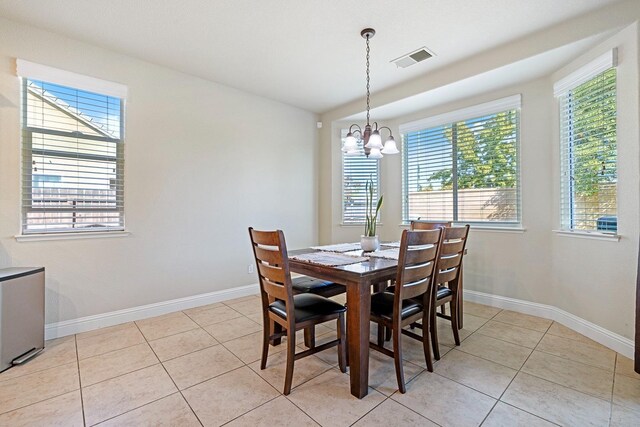 3313 Whiteash Ave, Clovis, CA 93619 - dining area with a chandelier, light tile patterned flooring, and baseboards