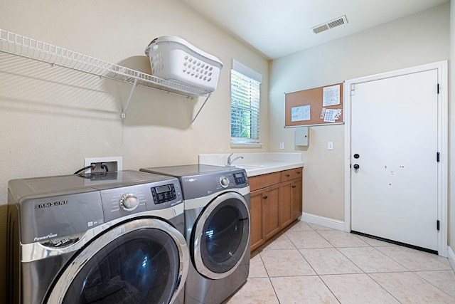 laundry room with sink, light tile patterned flooring, cabinets, and washer and clothes dryer