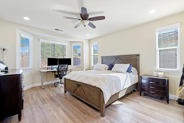 3313 Whiteash Ave, Clovis, CA 93619 - bedroom with light wood finished floors, multiple windows, baseboards, and recessed lighting