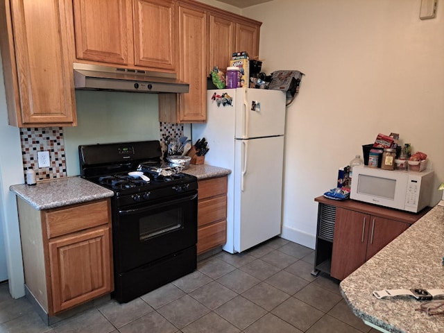 kitchen with light stone countertops, light tile patterned floors, backsplash, and white appliances