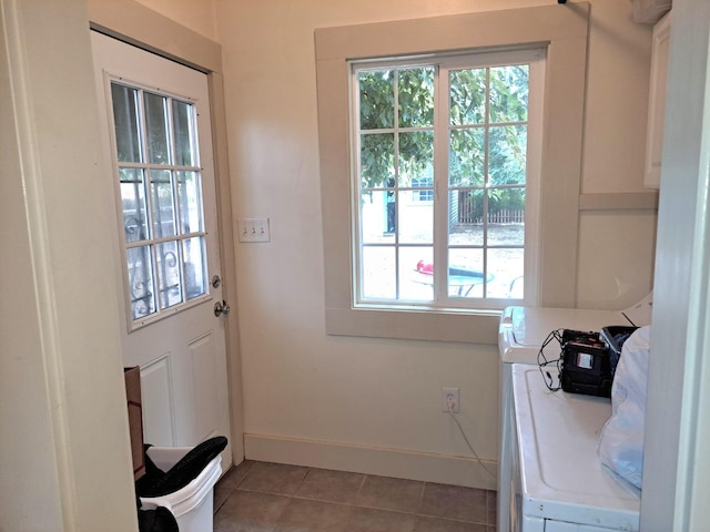 laundry area with light tile patterned flooring