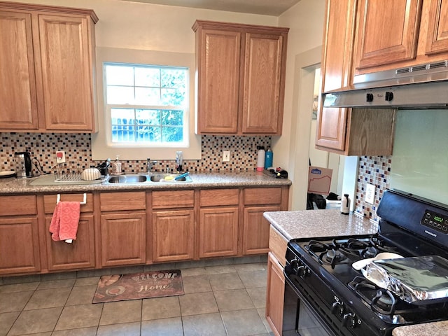 kitchen featuring sink, range hood, black range with gas cooktop, decorative backsplash, and light tile patterned floors