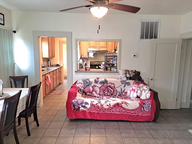 tiled living room featuring sink and ceiling fan