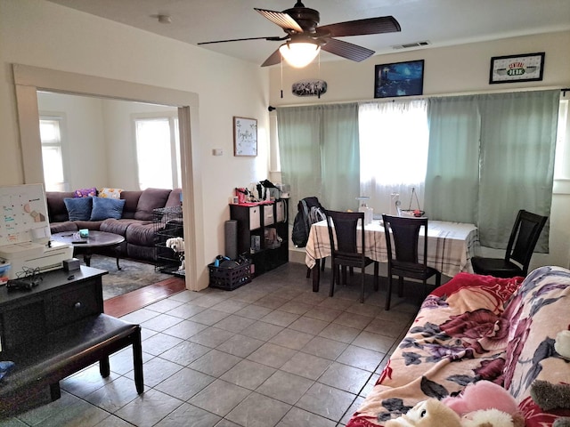 living room featuring ceiling fan and light tile patterned flooring