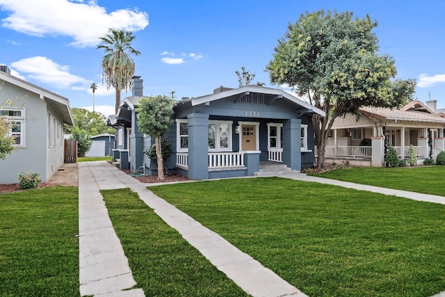 bungalow-style house with a front lawn and covered porch