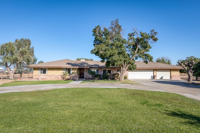 ranch-style house featuring a garage and a front lawn