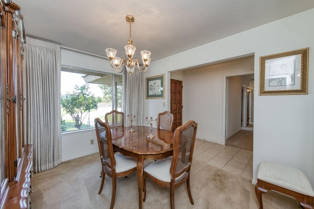 carpeted dining area with a textured ceiling and a chandelier