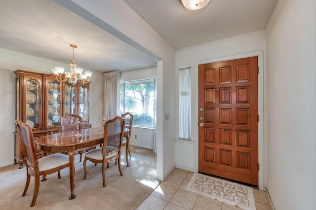 tiled dining room with a notable chandelier