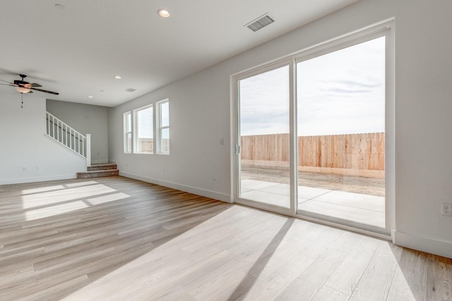 unfurnished living room with ceiling fan and light wood-type flooring