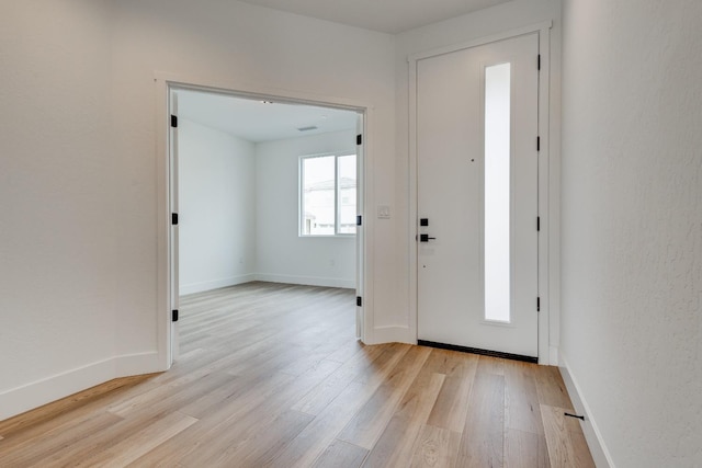 foyer entrance with light hardwood / wood-style floors