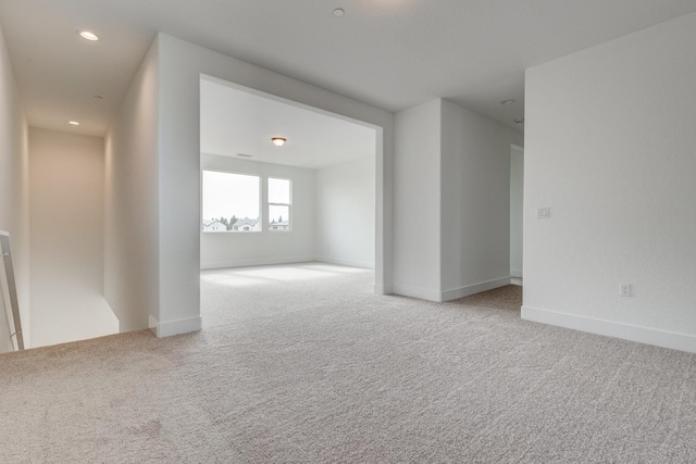 unfurnished room with light carpet