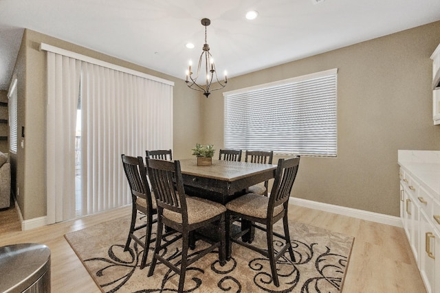 dining area with a notable chandelier and light wood-type flooring