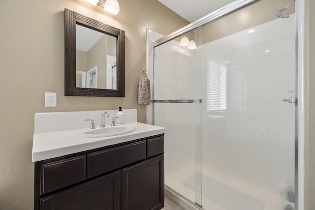 bathroom featuring vanity and a shower with shower door