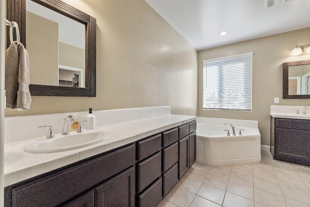 bathroom with vanity, a bath, and tile patterned flooring