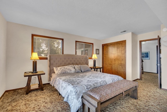 bedroom featuring a closet, carpet flooring, and a textured ceiling