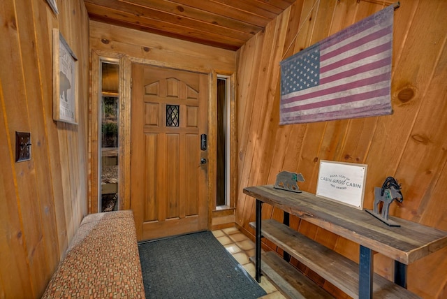 foyer with wooden walls and wood ceiling