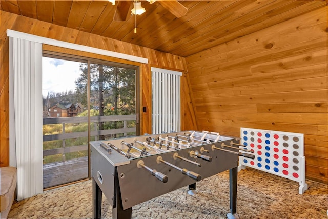 playroom with wood ceiling, wooden walls, and ceiling fan