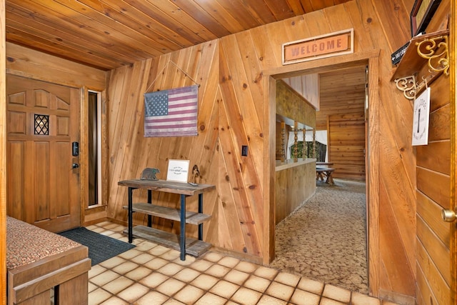 entryway with wood ceiling and wooden walls