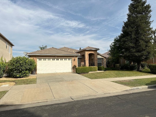 mediterranean / spanish-style home featuring driveway, a tile roof, an attached garage, a front lawn, and stucco siding