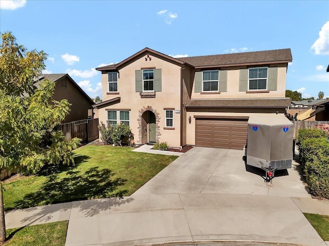 view of front of home featuring a front yard and a garage