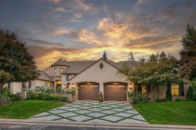 view of front of house with a garage and a lawn