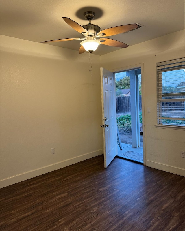 empty room featuring ceiling fan and dark hardwood / wood-style flooring