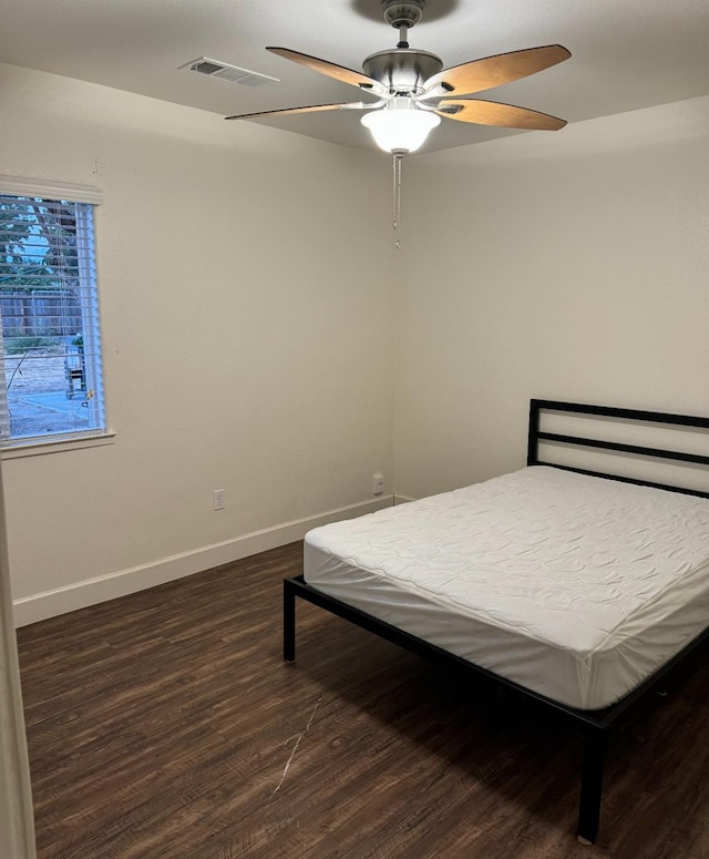 bedroom with dark wood-type flooring and ceiling fan