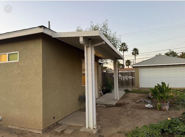 property exterior at dusk featuring a garage