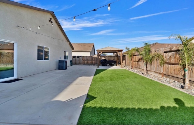 view of yard featuring a gazebo, cooling unit, and a patio