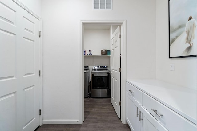 hallway featuring separate washer and dryer and dark hardwood / wood-style floors