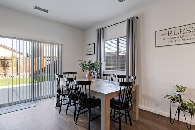 dining space featuring dark wood-type flooring