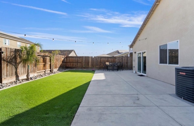 view of yard featuring central air condition unit and a patio