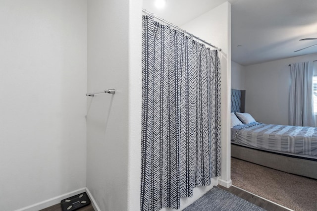 bathroom with wood-type flooring and ceiling fan