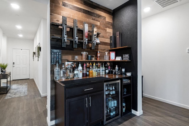 bar featuring wine cooler and dark hardwood / wood-style flooring