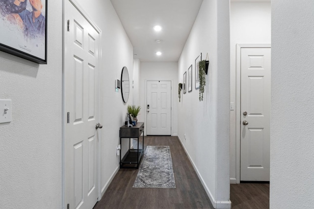 hall with dark hardwood / wood-style flooring